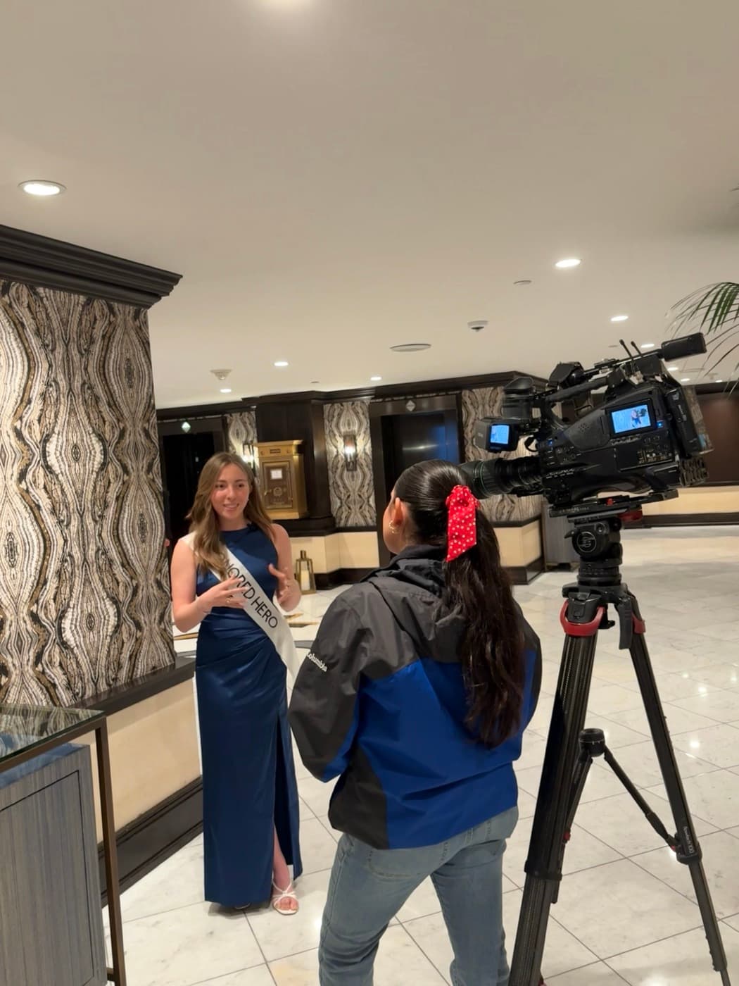 Natalia in her Visionaries sash being filmed during an awareness campaign
