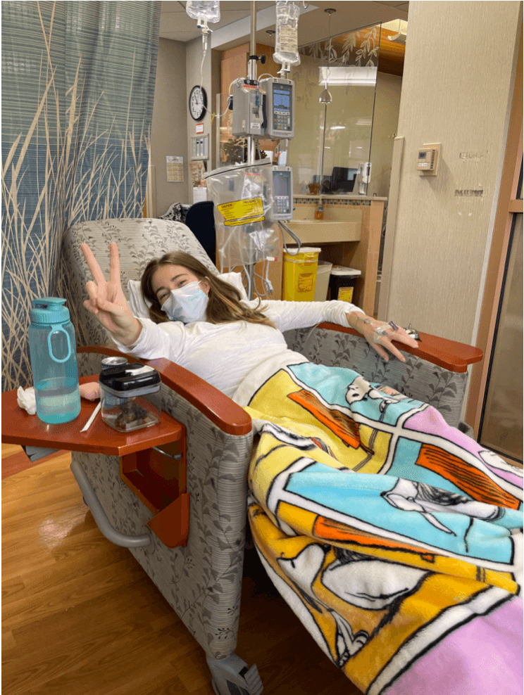 Natalia giving a peace sign during treatment